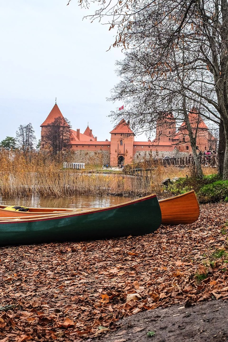 Two canoes are waiting for paddlers, while these exploring the castle of Trakai