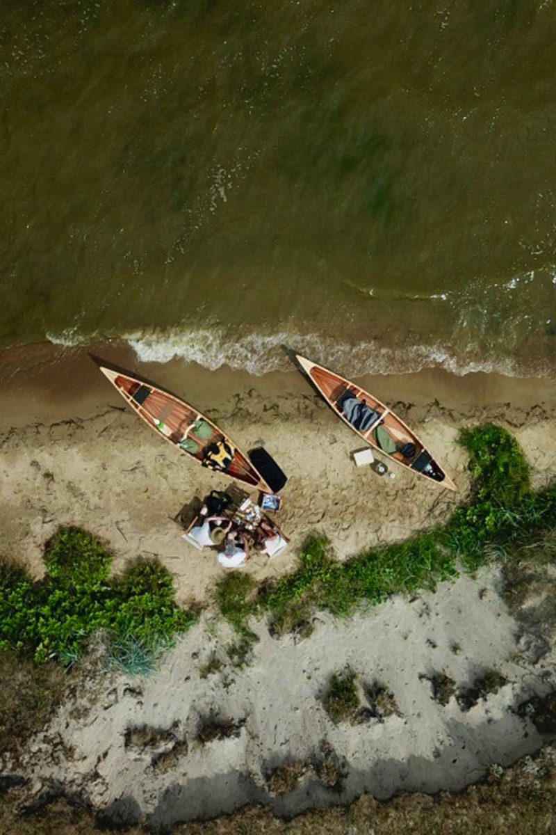 Tourists enjoying picnic during a canoe tour