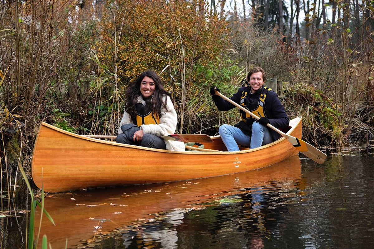 Couple exploring hidden spots, during canoe tour in Trakai, Litbuania