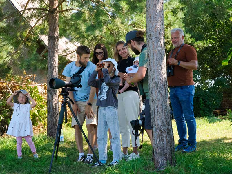 Family is observing birds with Boris during Swarowski birdwatching event